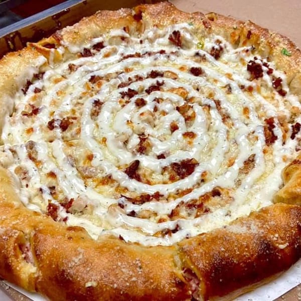 Franco's Italian pizza with a spiral of white sauce, cheese, and meat toppings.