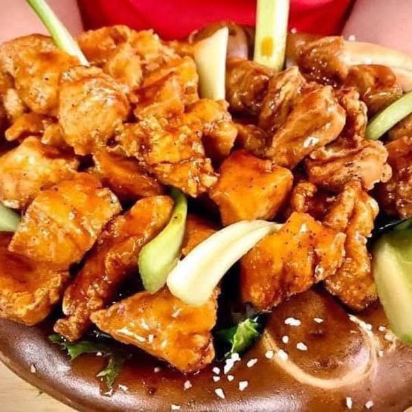 Franco's Italian restaurant serves a plate of crispy, glazed chicken bites with celery and sesame seeds.